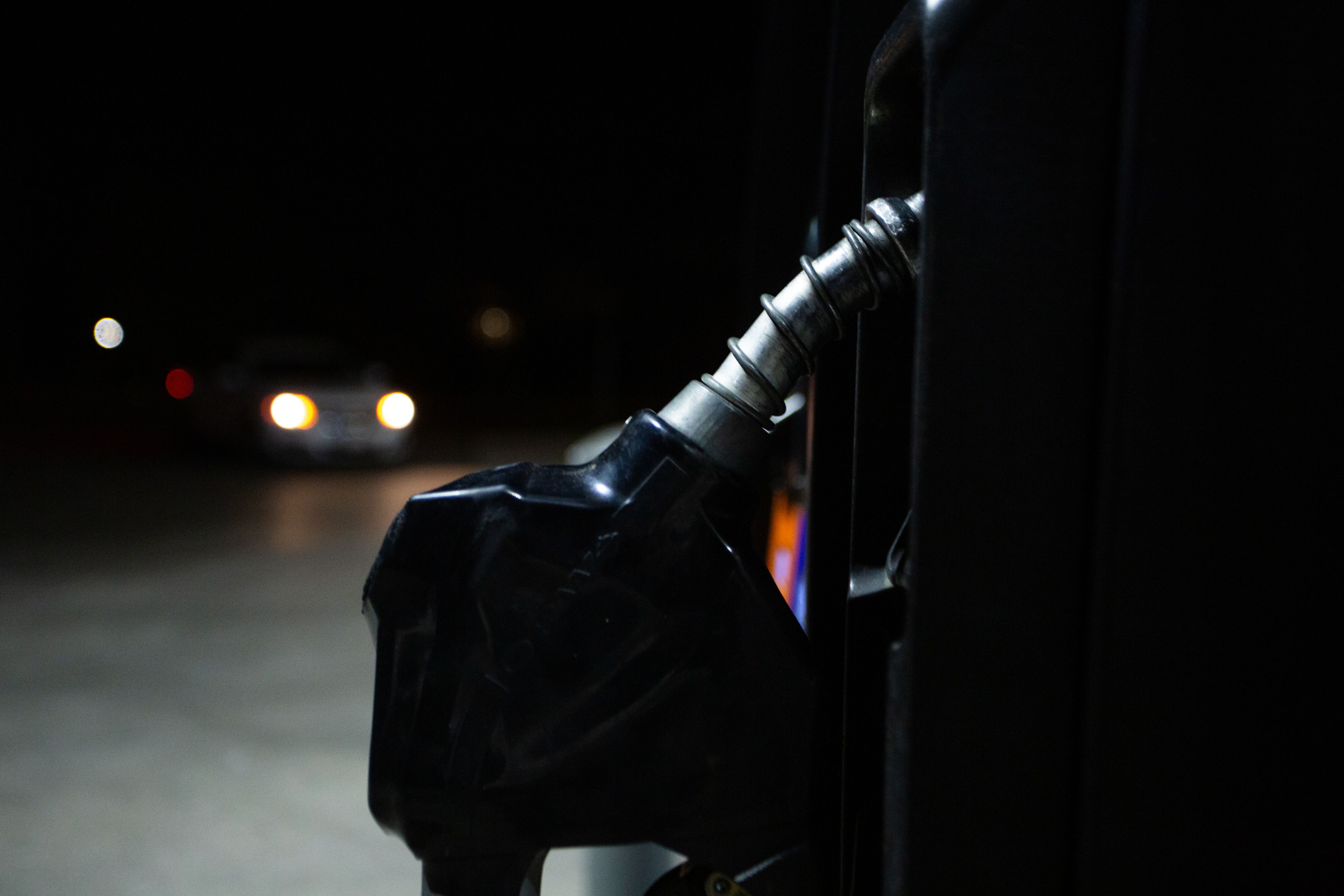 A close up of gas pump is seen at night.