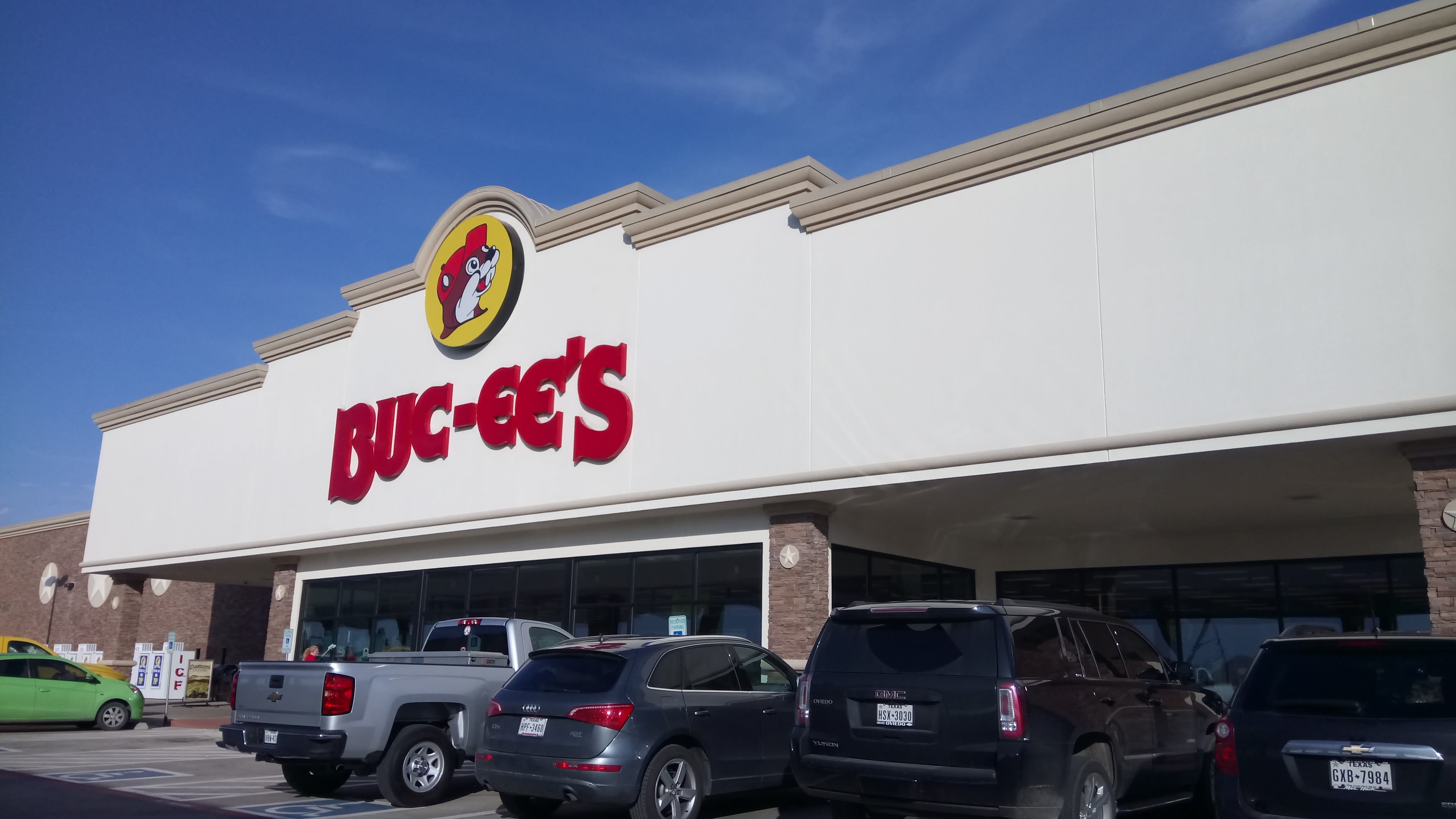 A modern-day photos of a Buc-ee's storefront is seen, the beaver logo prominent.